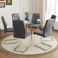 Table And Chair Set.A Modern Minimalist Round Dining Table With Transparent Tempered Glass Top And Silver Metal Legs,And 6 Chairs With Pu Backrest And Seat Cushion And Silver C Tube Metal Legs. Dark Gray,Transparent Seats 6 Glass Metal