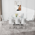 Table And Chair Set.Contemporary, Minimalist Rectangular Dining Table Featuring A Clear Tempered Glass Top And Sleek Silver Legs. Paried With Chairs Made Of Pu Material Cushion And Silver Metal Legs. White Seats 8 Glass Metal