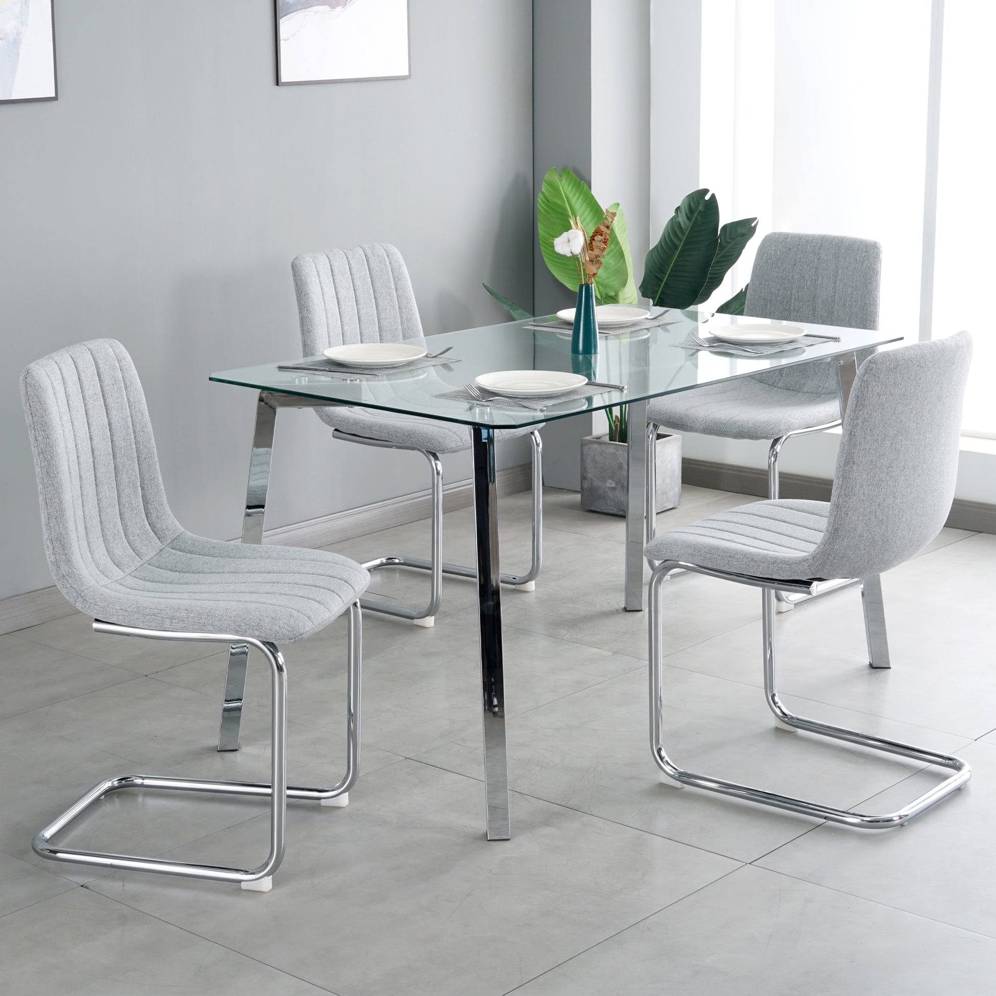 Table And Chair Set, One Table And Four Chairs. Clear Tempered Glass Table Top, 0.3 Feet Thick, Silver Metal Legs. Bow Chair With Electroplated Metal Legs. Upholstered Chair Glass Light Gray Metal