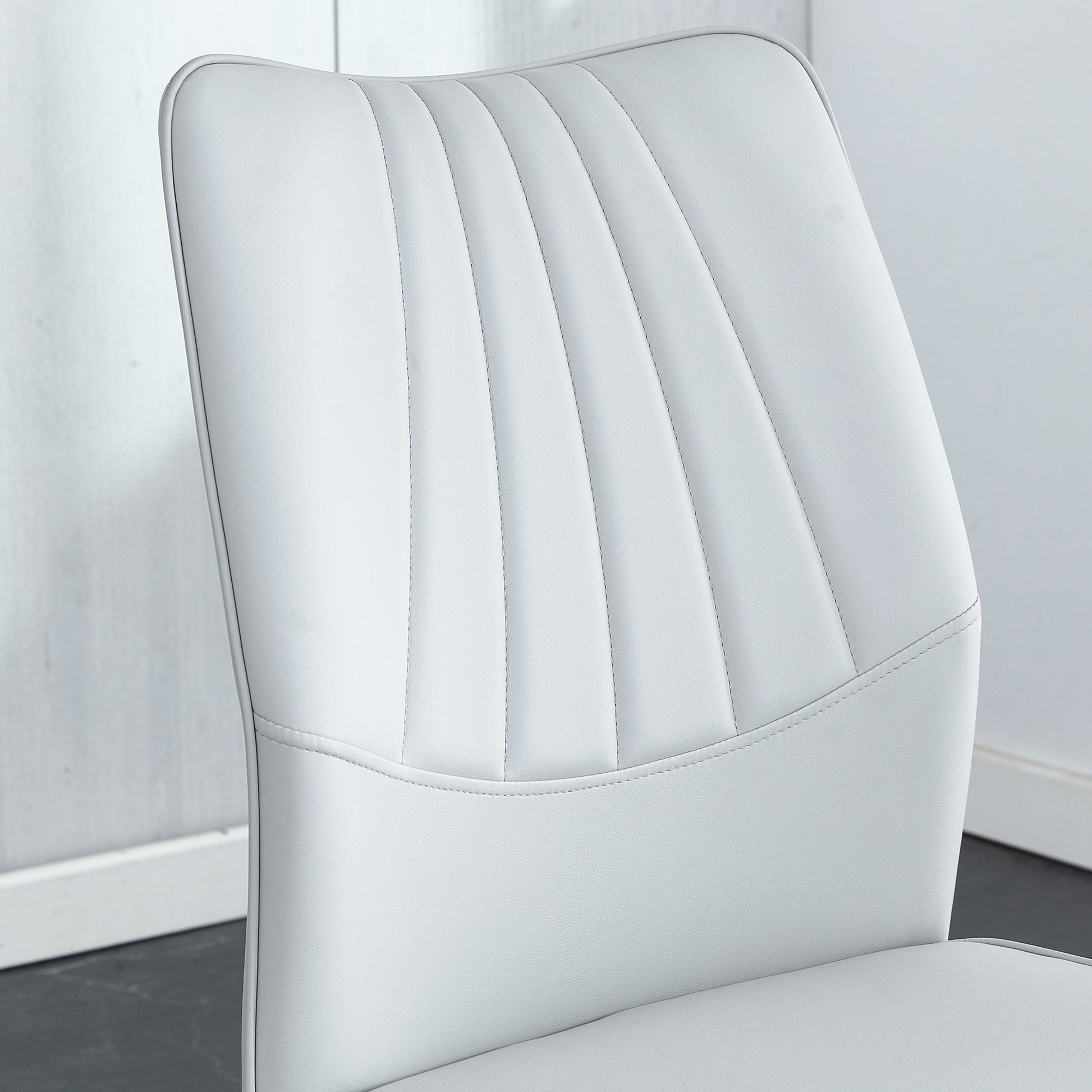 Four Light Gray Dining Chairs. A Medieval Modern Chair Made Of Pu Material With Soft Cushions And Silver Metal Legs. Suitable For Restaurants And Living Rooms Light Gray Pu