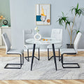 Table And Chair Set. Large Modern White Imitation Marble Patterned Round Table With Black Metal Legs. Nice Minimalism, Comfortable Seats And Black Metal Legs. White Gray Seats 4 Glass Metal