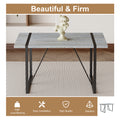 Table And Chair Set. A Minimalist Retro Rectangular Dining Table With A Specially Textured Top And Black Metal Legs, Paired With 6 Soft Chairs And Black Metal Legs, Showcases A Beautiful Home Style.