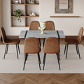 Table And Chair Set. A Minimalist Retro Rectangular Dining Table With A Specially Textured Top And Black Metal Legs, Paired With 6 Soft Chairs And Black Metal Legs, Showcases A Beautiful Home Style.