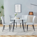 Table And Chair Set. Large Modern White Imitation Marble Patterned Round Table With Black Metal Legs. Nice Minimalism, Comfortable Seats And Black Metal Legs. White Gray Seats 4 Glass Metal