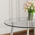 A Modern Minimalist Round Transparent Tempered Glass Table With Silver Metal Legs And 4 Modern Pu Leather High Backed Dining Chairs For A Luxurious Experience. Black Seats 4 Glass Metal