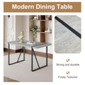 Table And Chair Set. A Minimalist Retro Rectangular Dining Table With A Specially Textured Top And Black Metal Legs, Paired With 4 Soft Chairs And Black Metal Legs, Showcases A Beautiful Home Style.