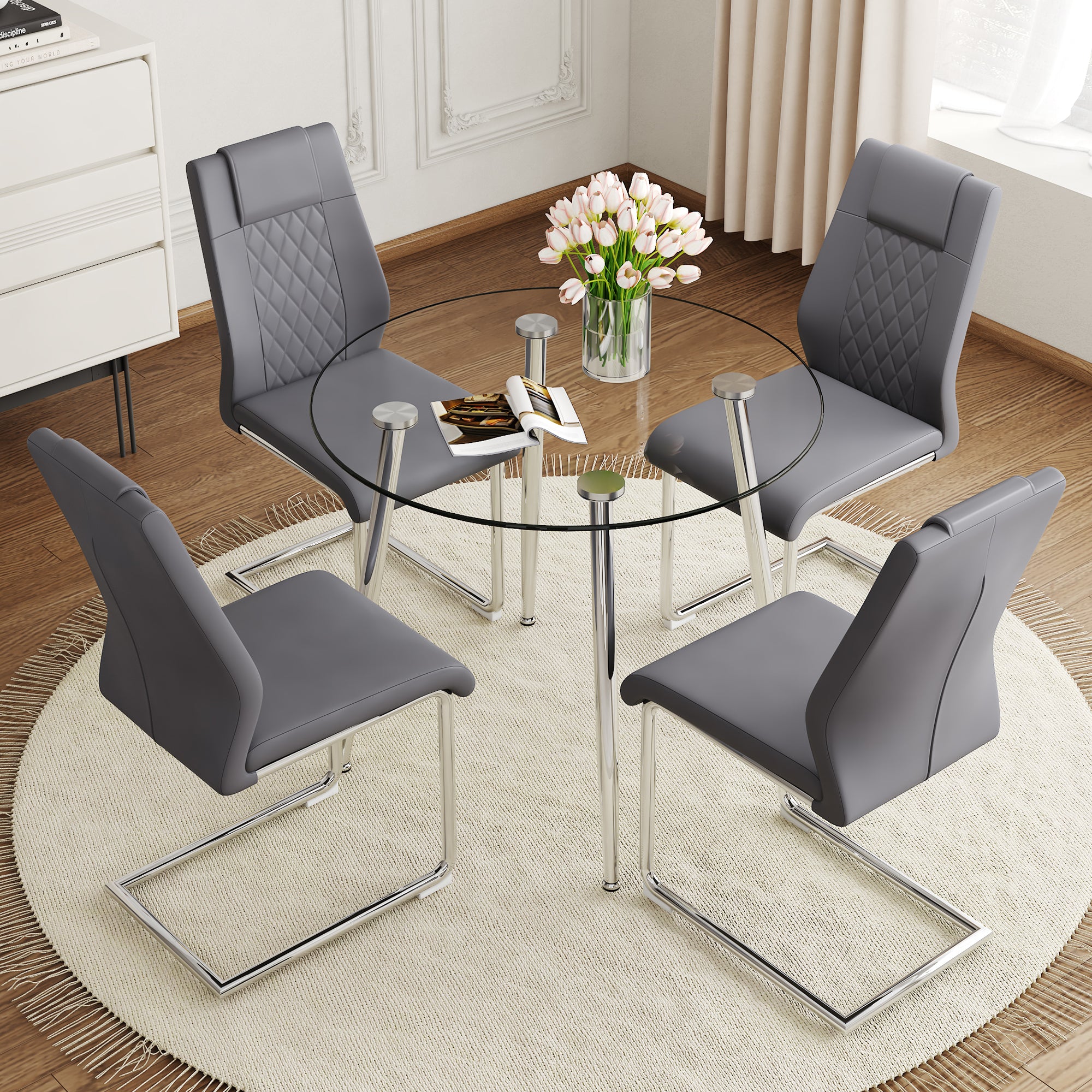 A Modern Minimalist Round Transparent Tempered Glass Table With Silver Metal Legs And 4 Modern Pu Leather High Backed Dining Chairs For A Luxurious Experience. Gray Seats 4 Glass Metal