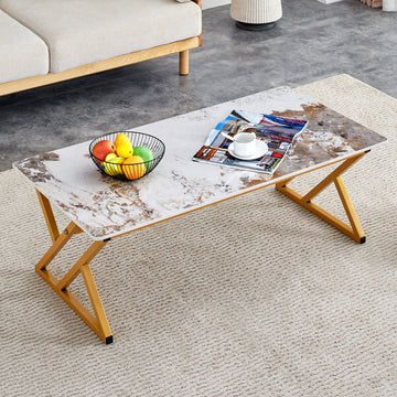 A Coffee Table Is Made Of Rock Slab Material, With A Natural And Smooth Marble Pattern On The Surface, Which Complements The Modern Design Of The Golden Metal Legs And Adds A Touch Of Fashion.47*23.6 Gold Sintered Stone