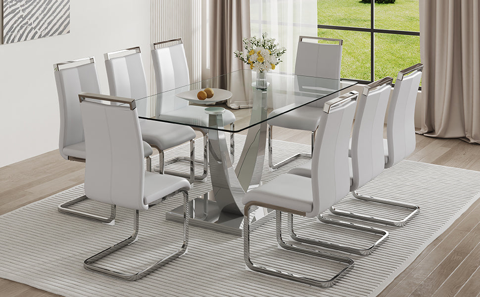 Table And Chair Set. Large Modern Rectangular Table With Glass Top And Silver Metal Legs. Furnished With Soft And Comfortable Pu Chairs With Faux Leather Upholstered Seats And Silver Metal Legs. Gray Silver Seats 6 Glass Metal