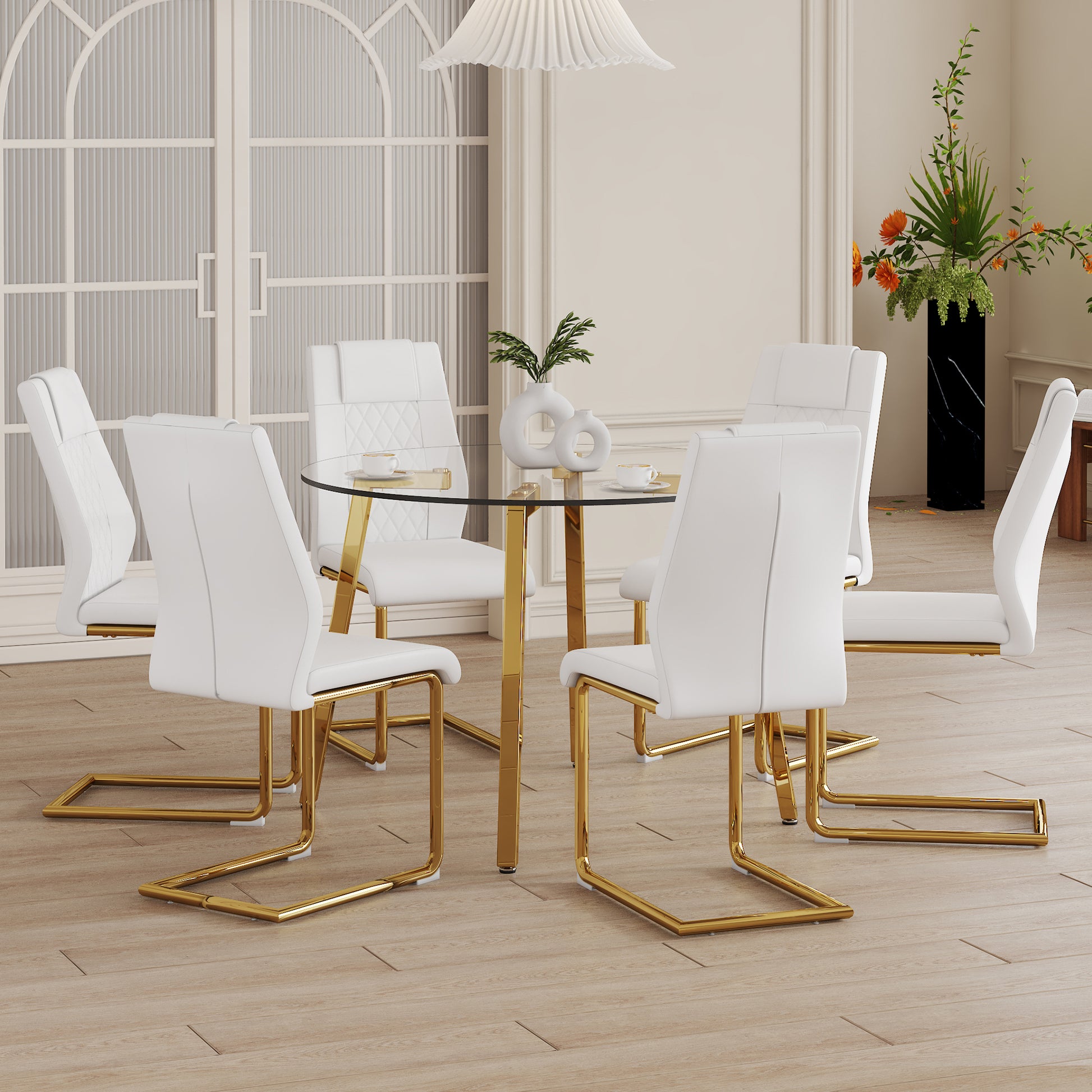 Table And Chair Set.A Modern Minimalist Style Round Clear Tempered Glass Table With Metal Legs.Paried With White Chairs With Modern Pu Leather High Back Upholstered And C Tube Golden Legs. Transparent Seats 6 Glass