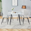 Table And Chair Set. Large Modern White Imitation Marble Patterned Round Table With Black Metal Legs. Nice Minimalist With Transparent Seats And Black Metal Legs. White Black Seats 4 Glass Metal