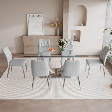 Table And Chair Set.Contemporary, Minimalist Rectangular Dining Table Featuring A Clear Tempered Glass Top And Sleek Silver Legs. Paried With Chairs Made Of Pu Material Cushion And Silver Metal Legs. Light Gray Seats 6 Glass Metal